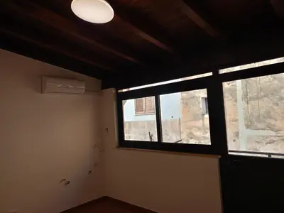 a room with a large window in a building at Fabian Appartament in Bagheria