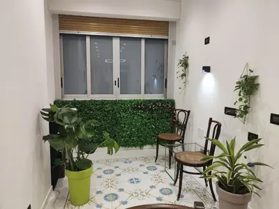 a room with a window with chairs and plants at Susy's home in Palermo