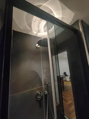 a shower with a glass door in a room at Susy's home in Palermo