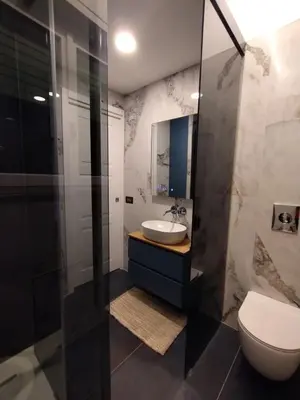 a bathroom with a sink and a toilet and a mirror at Susy's home in Palermo