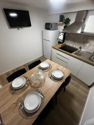 a kitchen with a wooden table with plates on it at A CASA DI LILLY - BALLARò' - in Palermo
