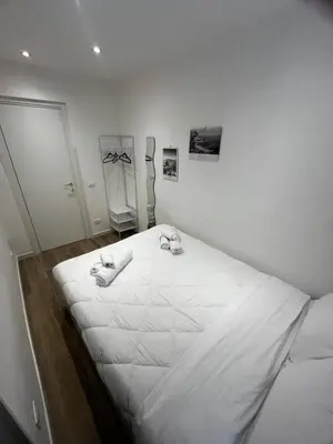 a large white bed in a white room with at A CASA DI LILLY - BALLARò' - in Palermo