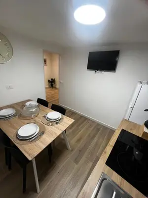 a kitchen and dining room with a table and a television at A CASA DI LILLY - BALLARò' - in Palermo