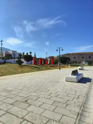 a park with a bench in the middle at Cala38 in Terrasini