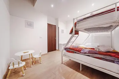 a bedroom with a bunk bed and a table at Maison Vulpi in Palermo