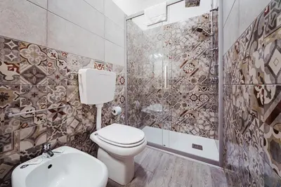 a bathroom with a toilet and a shower at Maison Vulpi in Palermo