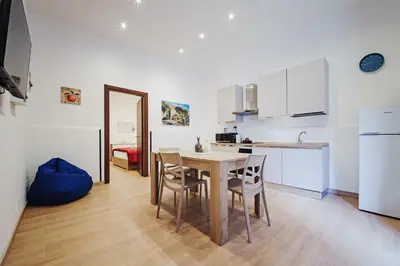 a kitchen and dining room with a table and chairs at Maison Vulpi in Palermo