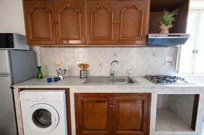 a kitchen with a sink and a washing machine at iFlat Casa Sant'Agata in Palermo