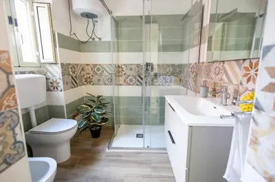 a bathroom with a shower and a toilet and a sink at iFlat Casa Sant'Agata in Palermo