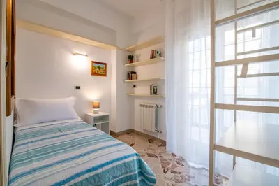a bedroom with a bed and a window at GuestHost - Lovely Flat near Palazzo dei Normanni in Palermo