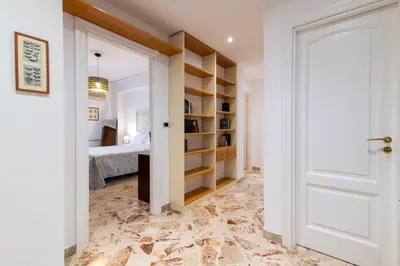 a hallway with a bedroom with a bed and a door at GuestHost - Lovely Flat near Palazzo dei Normanni in Palermo
