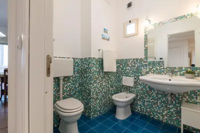 a bathroom with a toilet and a sink at GuestHost - Lovely Flat near Palazzo dei Normanni in Palermo