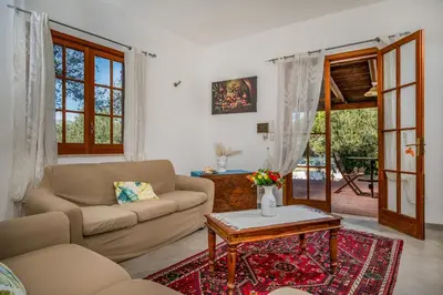 a living room with a couch and a table at Villa Giummara Cala bianca in Castellammare del Golfo