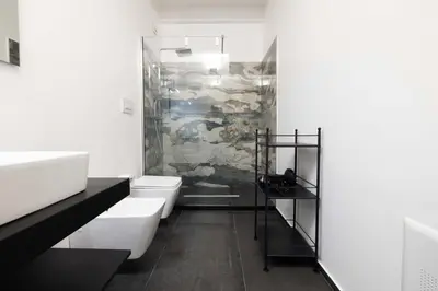 a bathroom with two white toilets and a shower at Ciuri di Sicilia Apartments in Castellammare del Golfo