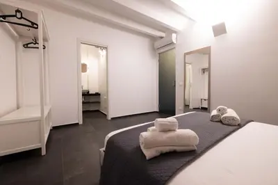 a bedroom with a bed with towels on it at Ciuri di Sicilia Apartments in Castellammare del Golfo