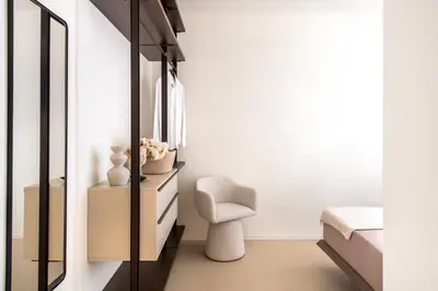 a bedroom with a chair and a mirror at Casa Marella in Balestrate