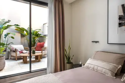a bedroom with a bed and a view of a living room at Casa Marella in Balestrate