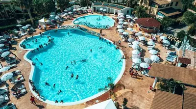 an overhead view of two large swimming pools with umbrellas at La terrazza vent8 in Buonfornello