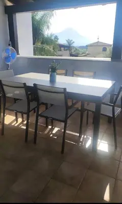 a white table and chairs in a room with a window at La terrazza vent8 in Buonfornello