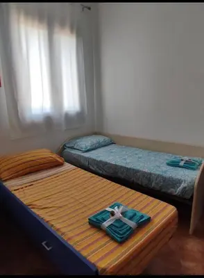 two beds in a bedroom with a cross on them at La terrazza vent8 in Buonfornello