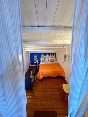 a bedroom with a bed with an orange bedspread at Casa del Teatro in Palermo