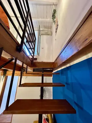 a room with wooden stairs and a blue wall at Casa del Teatro in Palermo