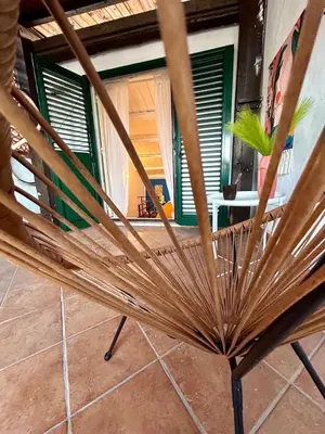 a wooden chair sitting in front of a window at Casa del Teatro in Palermo