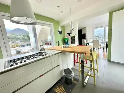 a kitchen with a table and a stove top oven at Villa With Citrus Grove Near Caccamo in Termini Imerese