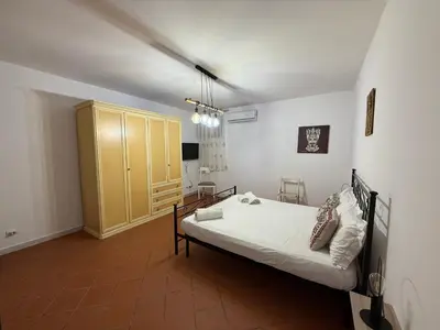 a bedroom with a bed and a yellow cabinet at Dal Moro in Palermo
