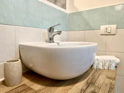 a bathroom with a white sink in a room at Dal Moro in Palermo