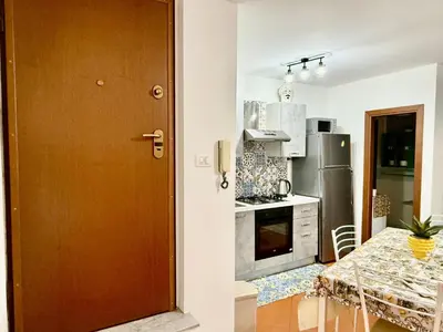a kitchen with a wooden door and a kitchen with a table at Dal Moro in Palermo
