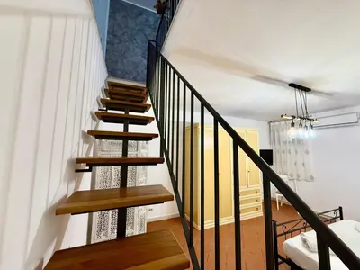 a spiral staircase in a living room with a couch at Dal Moro in Palermo