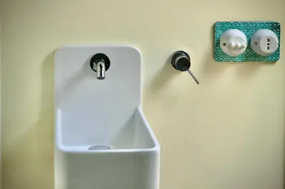 a sink on a wall with a fosset at Villa Halcón, casale con piscina tra gli ulivi, vicino al mare tra Balestrate e Alcamo in Partinico
