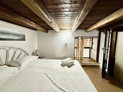 a bedroom with a bed with a towel on it at Casa del Cortile Secco in Palermo