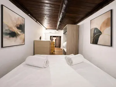 a bedroom with a white bed with two pillows on it at Casa del Cortile Secco in Palermo