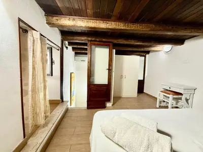 a bedroom with a white bed and a piano at Casa del Cortile Secco in Palermo