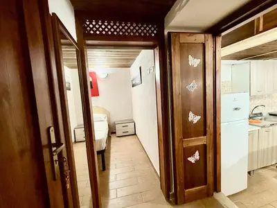a room with a hallway with a kitchen and a bedroom at Casa del Cortile Secco in Palermo