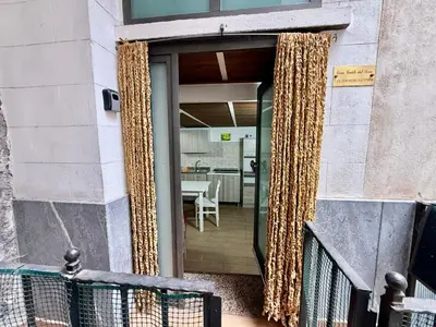 a sliding glass door with rope curtains on a building at Casa del Cortile Secco in Palermo
