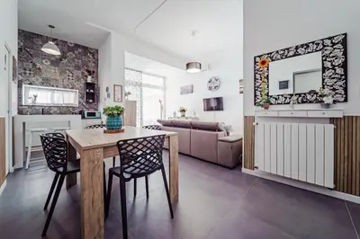 a kitchen and living room with a table and chairs at La Casetta di Simo & Leo in Palermo