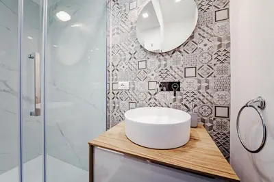 a bathroom with a white sink and a shower at La Casetta di Simo & Leo in Palermo