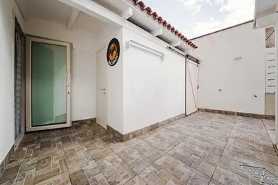 a room with a large white wall and a tile floor at La Casetta di Simo & Leo in Palermo