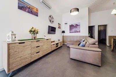 a living room with a couch and a tv at La Casetta di Simo & Leo in Palermo
