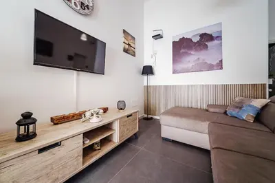 a living room with a couch and a flat screen tv at La Casetta di Simo & Leo in Palermo