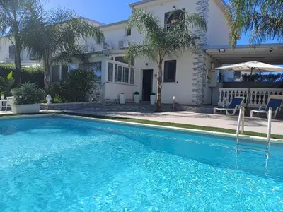 a swimming pool in front of a house at Villa del sole in Carini