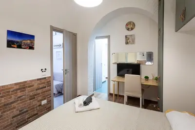 a bedroom with a bed and a desk in a room at Come A To Casa in Aspra