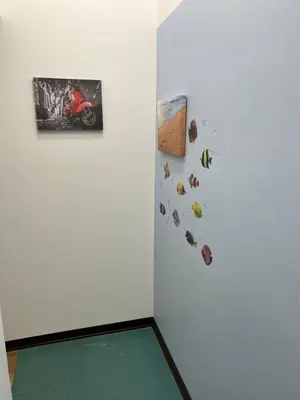 a corner of a room with a wall with pictures on it at Come A To Casa in Aspra