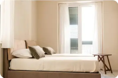 a bed in a room with a window at La Luna di Noah al Massimo in Palermo
