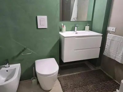 a bathroom with a white toilet and a sink at Venticinque Passi - nel cuore di Palermo in Palermo