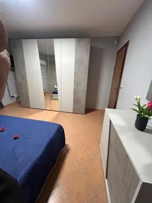 a room with two beds and a desk with a laptop at Enza HOUSE in Balestrate
