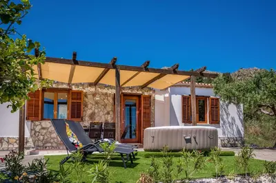 a house with a pergola in the yard at Vista Mare Scopello AC Jacuzzi 3 camere by Proger in Scopello